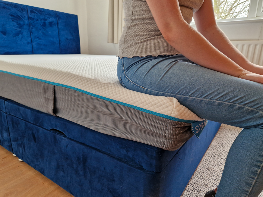 Sitting on the edge of the Simbatex Foam mattress